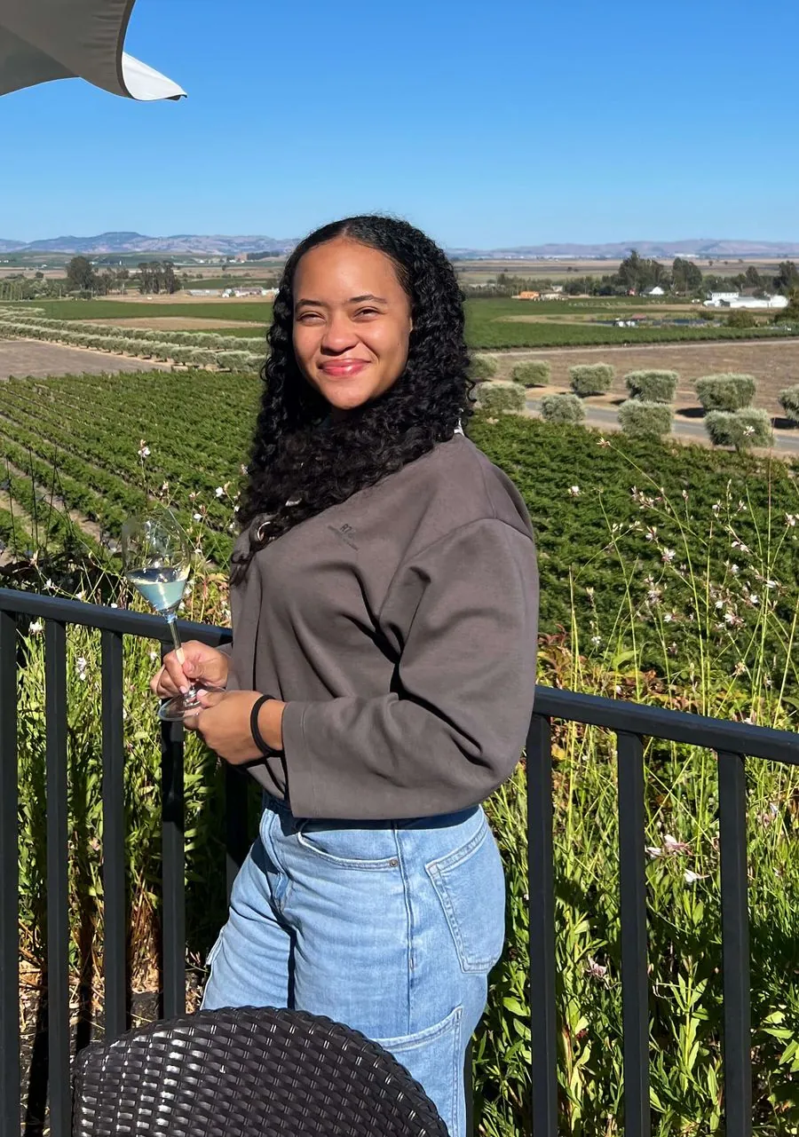 Sylena on a terrace overlooking a vineyard